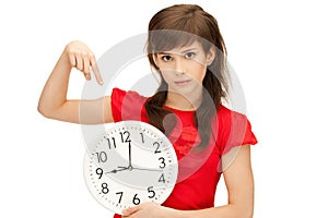 Teenage girl holding big clock