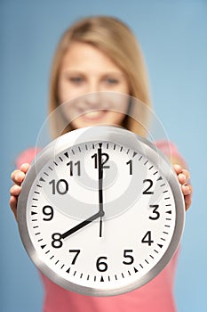 Teenage Girl Holding Clock