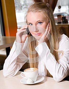 Teenage girl holding a cup of hot drink