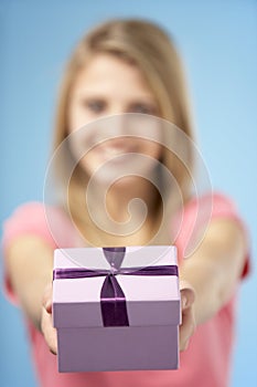 Teenage Girl Holding Gift Wrapped Box