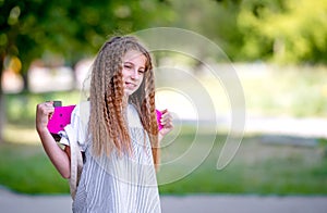 Teenage girl holding her pink board