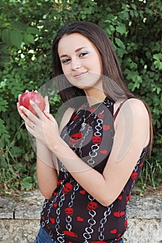 Teenage girl holding red apple