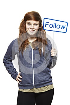 Teenage girl holding a social media sign smiling