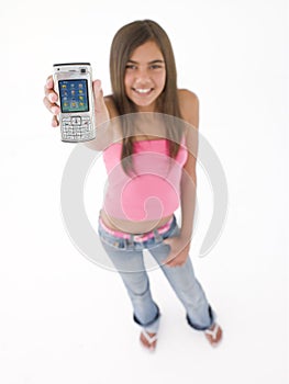 Teenage girl holding up cellular phone