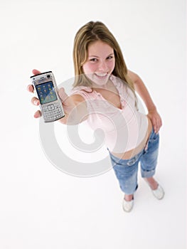 Teenage girl holding up cellular phone and smiling