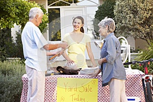 Teenage Girl Holding Yard Sale