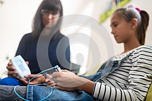 Teenage girl holding zapper electrodes