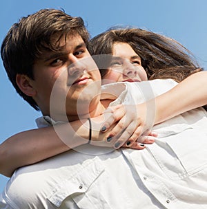 Teenage girl hugging boy