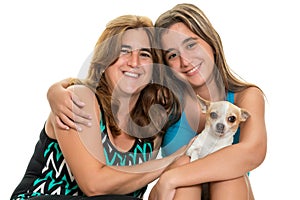Teenage girl hugging her mother and their little dog photo