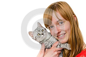 Teenage girl hugging young tabby cat