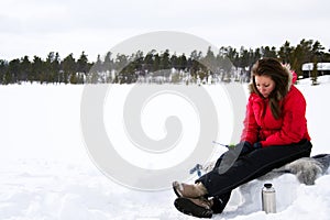 Teenage girl ice fishing