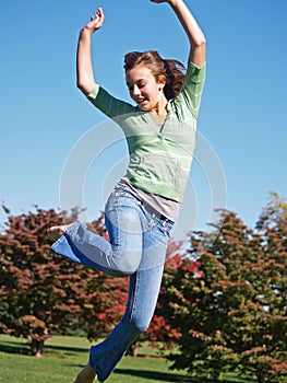 Teenage girl jumping in air