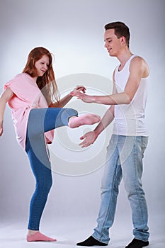 Teenage girl kicking a boy