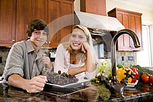 Teenage girl in kitchen with younger brother