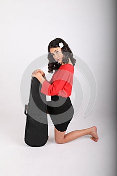 Teenage girl kneeling with violin case