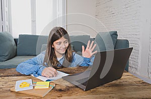 Teenage girl on laptop studying online at home as high school is closed due to new COVID-19 Lockdown