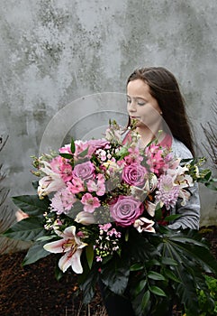 Teenage girl with large bunch of flowers