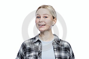 Teenage girl laughs. Cute blonde girl in a plaid shirt. Positive and optimistic. Isolated on a white background