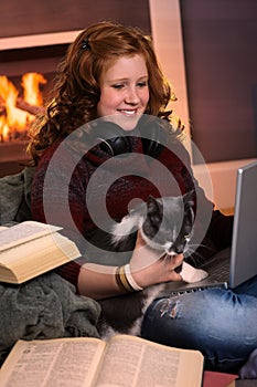 Teenage girl learning at home with cat