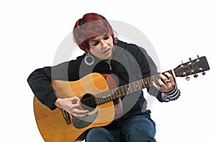 Teenage girl learning to play guitar