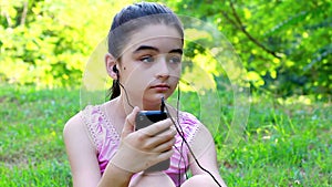Teenage girl listening to music on a smart phone