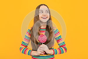 Teenage girl with lollipop, child eating sugar lollipops, kids sweets candy shop.