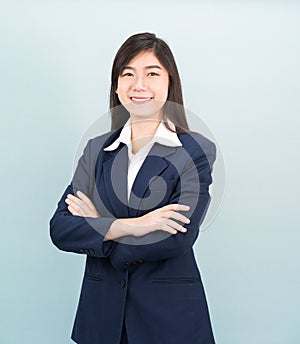 Teenage girl long hair is standing with her arms crossed