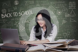 Teenage girl with long hair studying in class