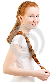 Teenage girl with long red plait photo