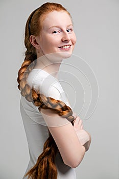 Teenage girl with long red plait