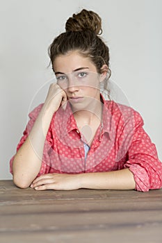 Teenage girl looking at camera with serious face. photo