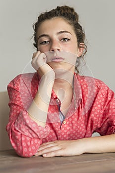 Teenage girl looking at camera with serious face. photo