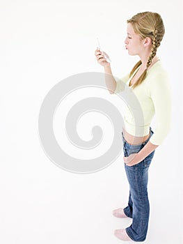 Teenage girl looking at cellular phone