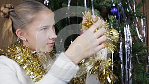 Teenage girl looking at Christmas garland