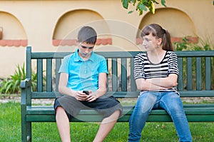 Teenage girl looking with love at indifferent teenage boy