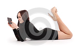 Teenage girl lying on the floor looking at tablet pc