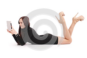 Teenage girl lying on the floor looking at tablet pc