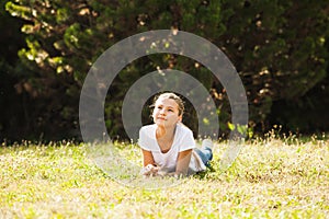 Teenage girl lying on the grass