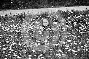 Teenage girl lying in the grass. Black and white photo