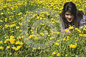 Teenage girl lying in spring meadow