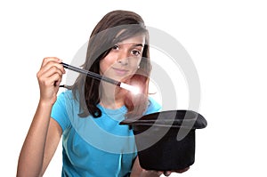 Teenage girl with magic wand and hat