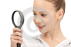 Teenage girl with magnifying glass