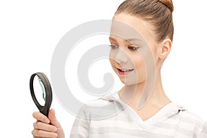 Teenage girl with magnifying glass