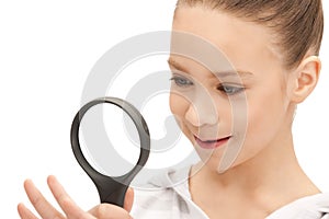 Teenage girl with magnifying glass