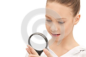 Teenage girl with magnifying glass