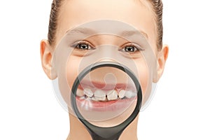 Teenage girl with magnifying glass showing teeth