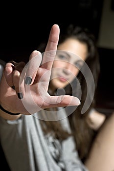 Teenage girl making a loser gesturing