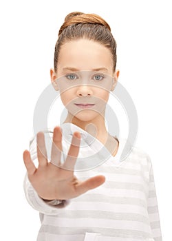 Teenage girl making stop gesture