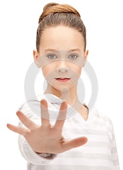 Teenage girl making stop gesture