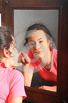 Teenage girl mirroring in mirror
